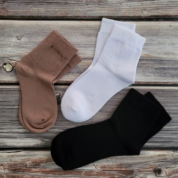 three pairs of socks in white, black, brown
